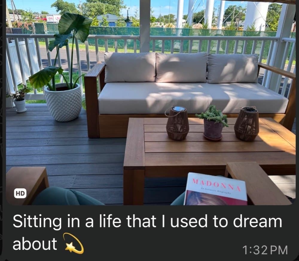 A photo of a sunlit porch sent by a client, with the message: Sitting in a life that I used to dream about.